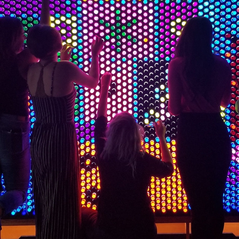 women interacting with 12x6 litezilla light wall