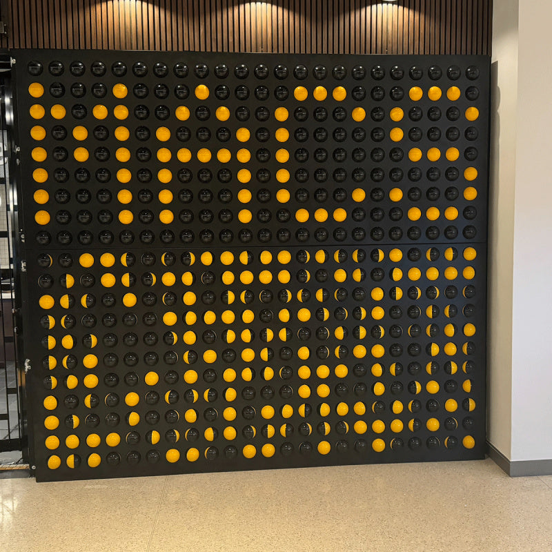 spinfinity wall with black and yellow rotating balls