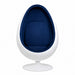 A modern egg-shaped pod chair with a white molded shell and a deep navy blue interior.