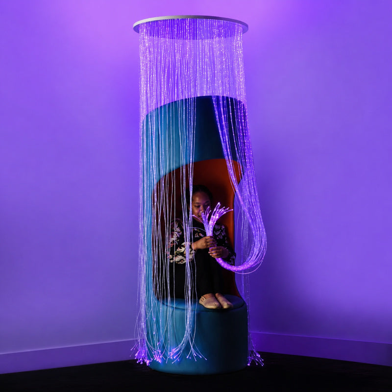kid sitting inside round sensory fiber optic curtain