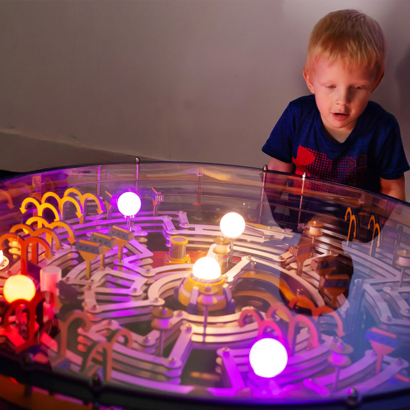 kid playing with interactive maze tabletop