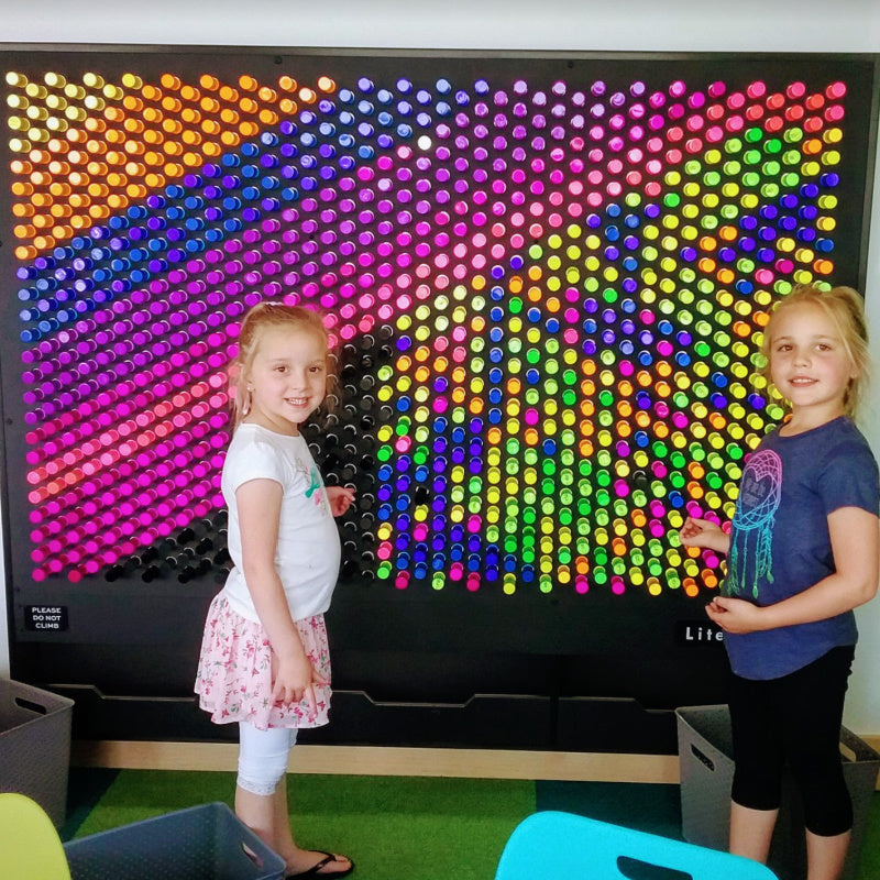 kids playing with litezilla light wall front view