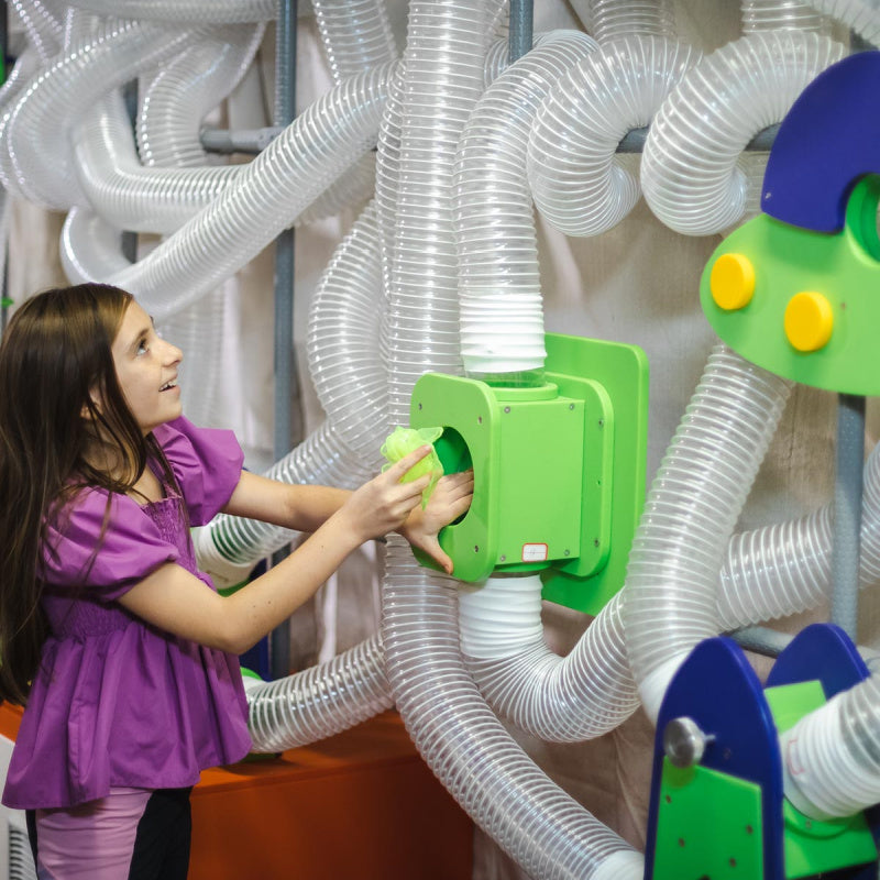 kid placing scarf in scarf launcher