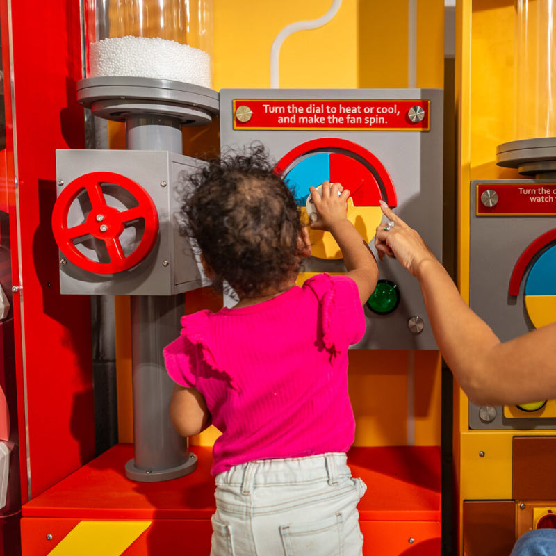 child playing with wind column tube 